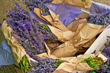 Purple lavender close up. Bunches of flowers and herbs are collected in a basket.