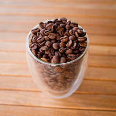 Coffee beans in a transparent glass glass. The smell of coffee. 