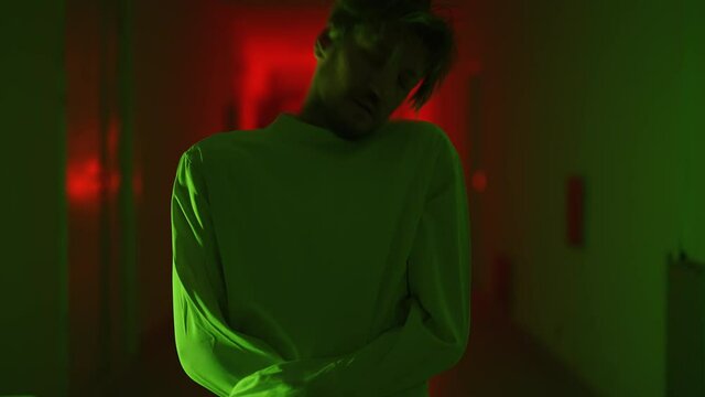 A mad male patient in straitjacket is going crazy in a mental hospital. Mentally ill man with psychic disorders and bipolar disease. Concept of paranoia or schizophrenia and madness or depression.