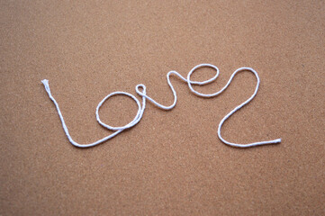 Photo of a Love text made with a whool thread -Symbol of love and romance, good for Valentine's Day and romantic events