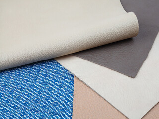 Natural leather textures samples on blue fabric background