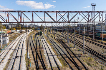 Electric trains are at the railway station in summer day