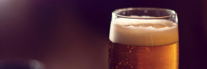 glass of beer close up on wooden table panorama - obrazy, fototapety, plakaty
