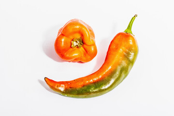 Ripe multicolored peppers isolated on white background