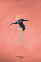 Fototapeta na wymiar Ballet dancer jumping doing a ballet pose in the air