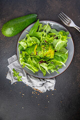 avocado salad lettuce leaf mix spinach, arugula, chard, lettuce fresh meal snack on the table copy space food background rustic. top view keto or paleo diet veggie vegan or vegetarian food