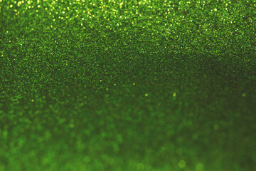Abstract shiny blurred green background. Textured glittering backdrop for your projects. Copy space