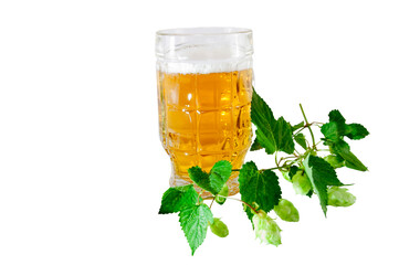 a glass of beer and a sprig of hops