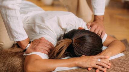 Fototapeta na wymiar Shiatsu Arms and Shoulder Massage. Therapist Massaging the Small and Large Intestine Meridians.