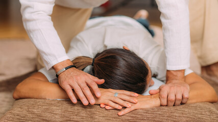 Fototapeta na wymiar Shiatsu Arms and Shoulder Massage. Therapist Massaging the Small and Large Intestine Meridians.