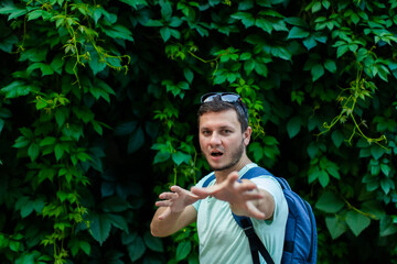 A young man in the park with a backpack