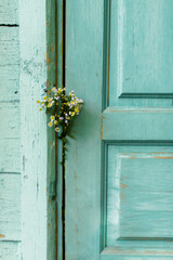 Bouquet of wildflowers and wooden door