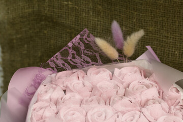 Marshmallow bouquet packed in craft paper. Zephyr rose flowers.