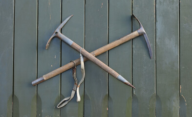 old ice ax on wooden background
