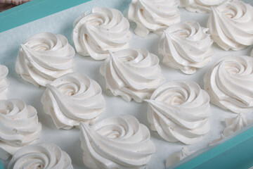 Homemade marshmallows of various shapes and colors are laid out on trays. Stabilization of Zephyr before packaging.