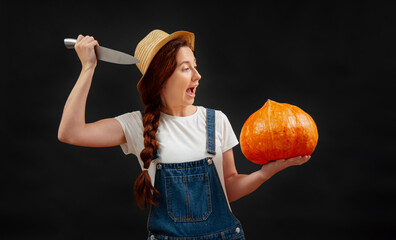 Farmer woman on a black background attacks a ripe pumpkin with a sharp knife. Concept of the Halloween holiday.