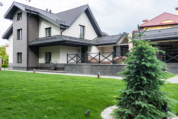 Fototapeta na wymiar Large house with walkway and lots of grass. Beautiful exterior of newly built luxury home.