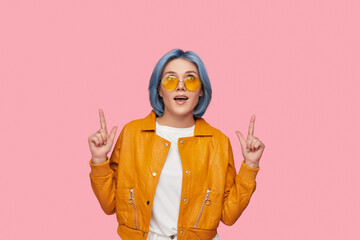 Trendy woman in sunglasses pointing up