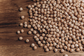 Raw chickpeas on a wooden table. Chickpea background. Healthy food concept