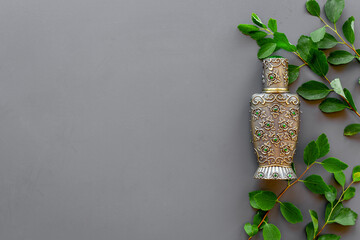 Silver bottle of arabian oud perfume or agar wood oil