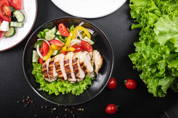 salad chicken breast meat poultry tomato, cucumber, onion, pepper, olive oil lettuce leaf mix fresh portion ready to eat meal snack on the table copy space food background rustic keto or paleo diet