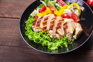 salad chicken breast meat poultry tomato, cucumber, onion, pepper, olive oil lettuce leaf mix fresh portion ready to eat meal snack on the table copy space food background rustic keto or paleo diet