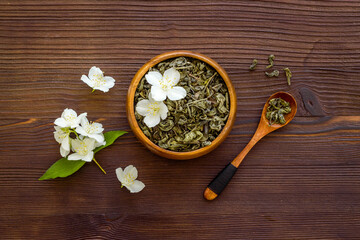 Jasmine flowers with dry tea in bowl. Top view