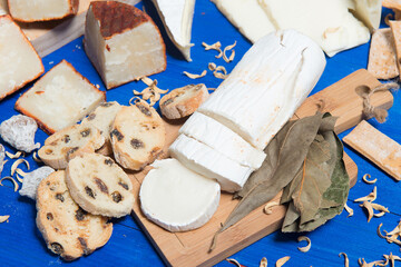 Table set with a cheese board and different kinds of delicious bread  