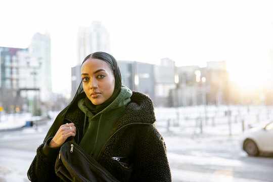 Portrait Beautiful Young Woman In Headscarf And Winter Coat In City