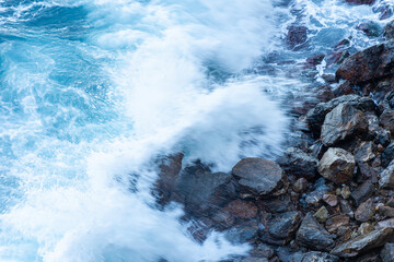 High angle view of waves crashing on rocks.