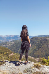 Naklejka premium Young woman with hat enjoying the beautiful high mountain view .Bov Village, Balkan Mountain, Iskar Gorge