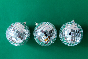 Disco ball against emerald green background