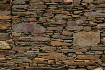 Background with wall texture with stone.
Wall view with natural stone arrangement.