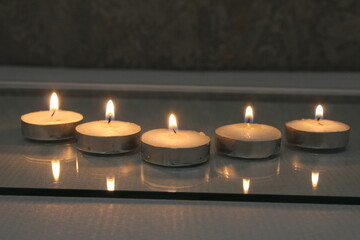 five small candles burn and stand in a triangle. side view. Divination Halloween Mystic