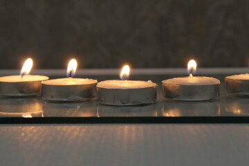 five small candles burn and stand in a triangle. side view. Divination Halloween Mystic