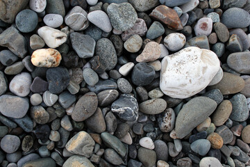 Sea coast, pebble beach background. Large beautiful stones for the background. The concept of tranquility.