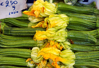 Zucchini and flowers for sale in Italy. - 459979490