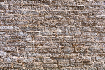 Old brick wall made of sandstone bricks as a natural background