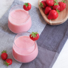 Glasses of fresh natural strawberries smoothie with natural yogurt for energy and health boosting, diet with healthy concept 