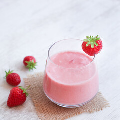 Glass of strawberry smoothie and natural yogurt for health benefit and diet, the drink well know as energy and immunity booster and high in vitamin and calcium 