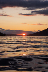 Fototapeta premium Canadian Nature Landscape View of the Gulf Islands on West Coast of Pacific Ocean. Dramatic Colorful Summer Sunset Located near Victoria, Vancouver Island, BC, Canada.