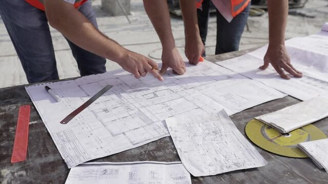 Concentrated professional male engineer drawing outlay of final construction plan as guide for builders with details of plumbing heating electrical ventilation and structural system