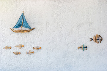 Boat and fish - picture on the wall of a restaurant on the on the Halki Island near Rhodes, Greece