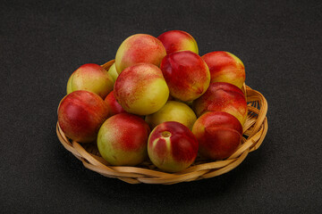 Sweet small nectarines in the basket