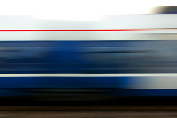 Long exposure shot photo of a fast moving, passing passenger train
