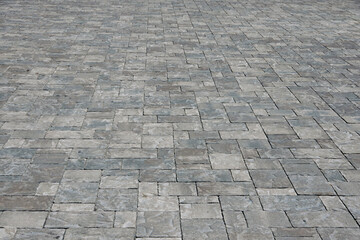 Full frame view with diminishing perspective of cement brick pavement