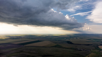 Aerial view on sunset over Romanian lowlands with windmills 
