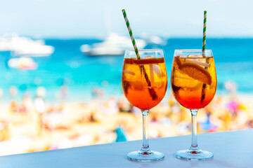 Two glasses with Aperol-Syringe cocktail on the beach 