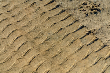 Impints of the truck tires on sand near quarry. Earthworks, offroad