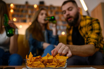 Bowl full of nachos on a table on a house party